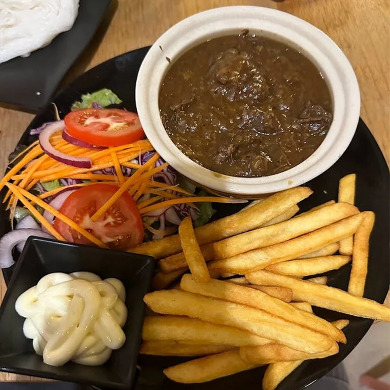 Belgian beer stew with fries and vegetables